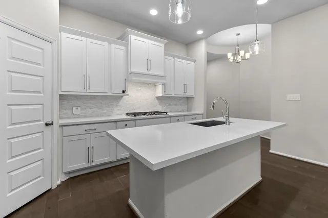 a kitchen with kitchen island a sink stainless steel appliances and cabinets