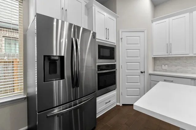 a kitchen with kitchen island granite countertop a sink a stove and cabinets
