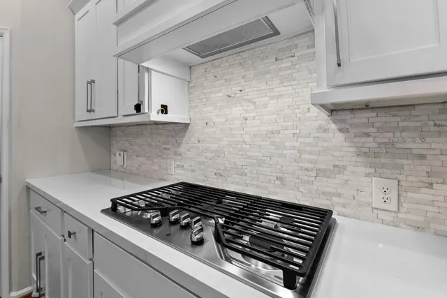 a kitchen with stainless steel appliances a refrigerator and cabinets