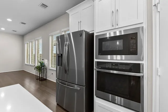 a kitchen with kitchen island a sink and a refrigerator