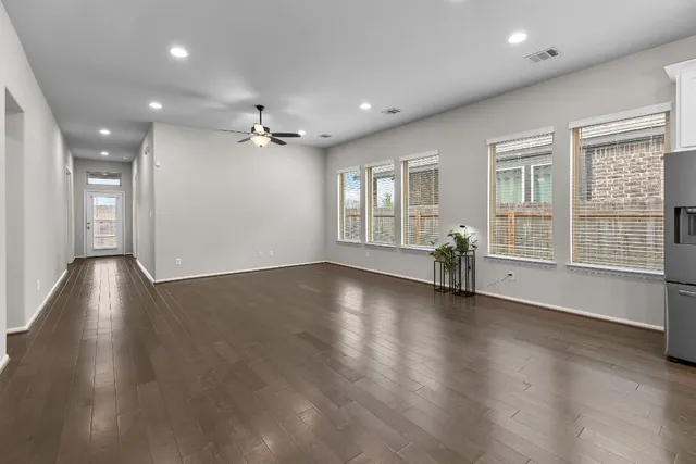 a metallic refrigerator freezer and a stove sitting inside of a kitchen
