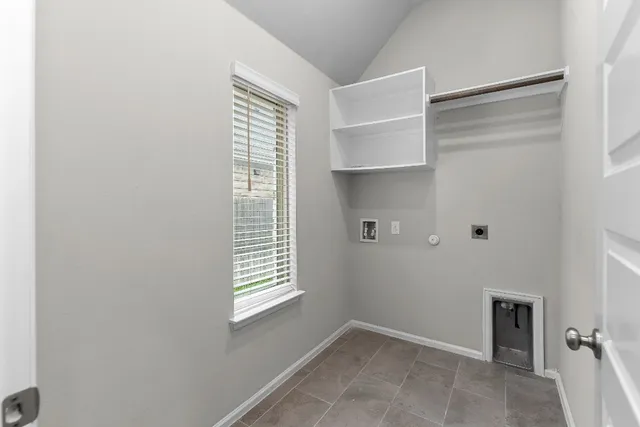 a view of an empty room with a window and closet