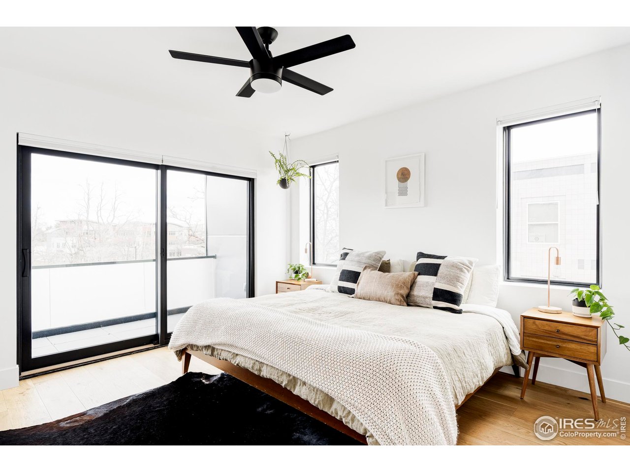 2465 Walnut Street, Unit 13 Boulder, CO 80302 - Photo 11 of 28 a bedroom with a bed a window and a chandelier