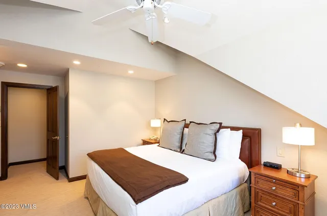 a bedroom with a bed and a night stand