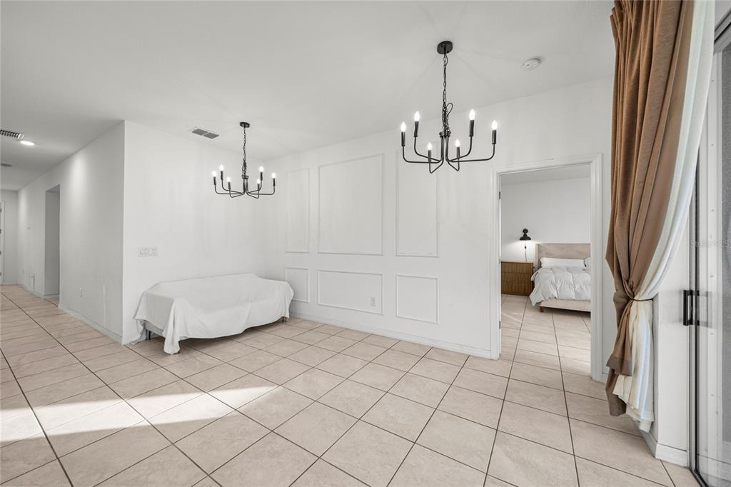 7664 Southwest 63rd Lane Road Ocala, FL 34474 - Photo 13 of 27 a view of a livingroom with a furniture wooden floor and a chandelier