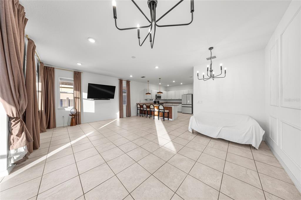 7664 Southwest 63rd Lane Road Ocala, FL 34474 - Photo 14 of 27 a living room with furniture and a flat screen tv