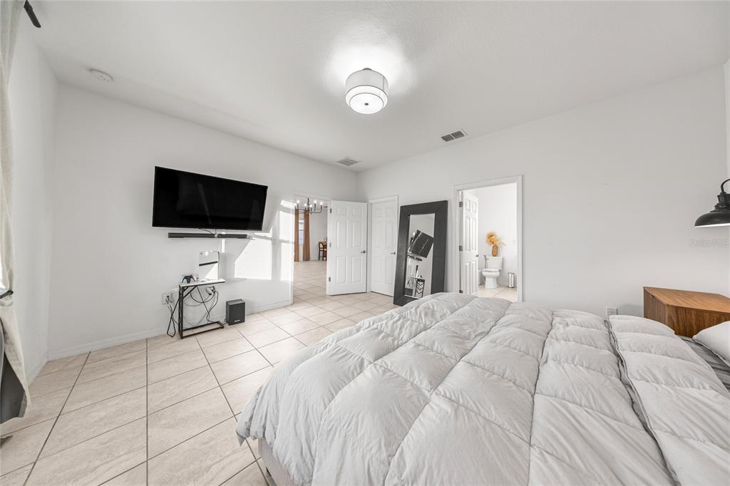 7664 Southwest 63rd Lane Road Ocala, FL 34474 - Photo 17 of 27 a bedroom with a bed and a flat screen tv