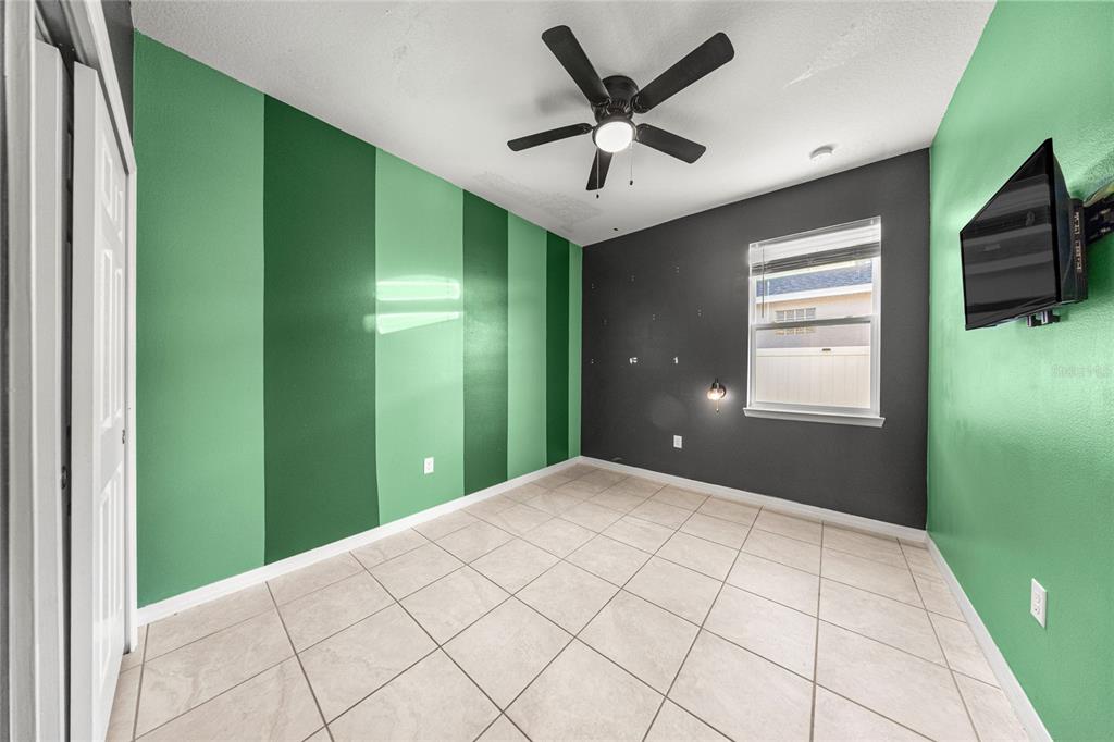 7664 Southwest 63rd Lane Road Ocala, FL 34474 - Photo 21 of 27 a view of a livingroom with a fan & a window