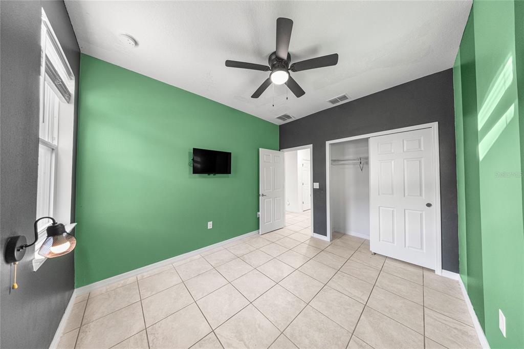 7664 Southwest 63rd Lane Road Ocala, FL 34474 - Photo 22 of 27 a bedroom with a bed and a large window