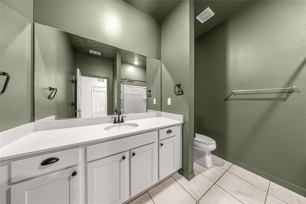 7664 Southwest 63rd Lane Road Ocala, FL 34474 - Photo 23 of 27 a spacious bathroom with a granite countertop sink mirror and toilet