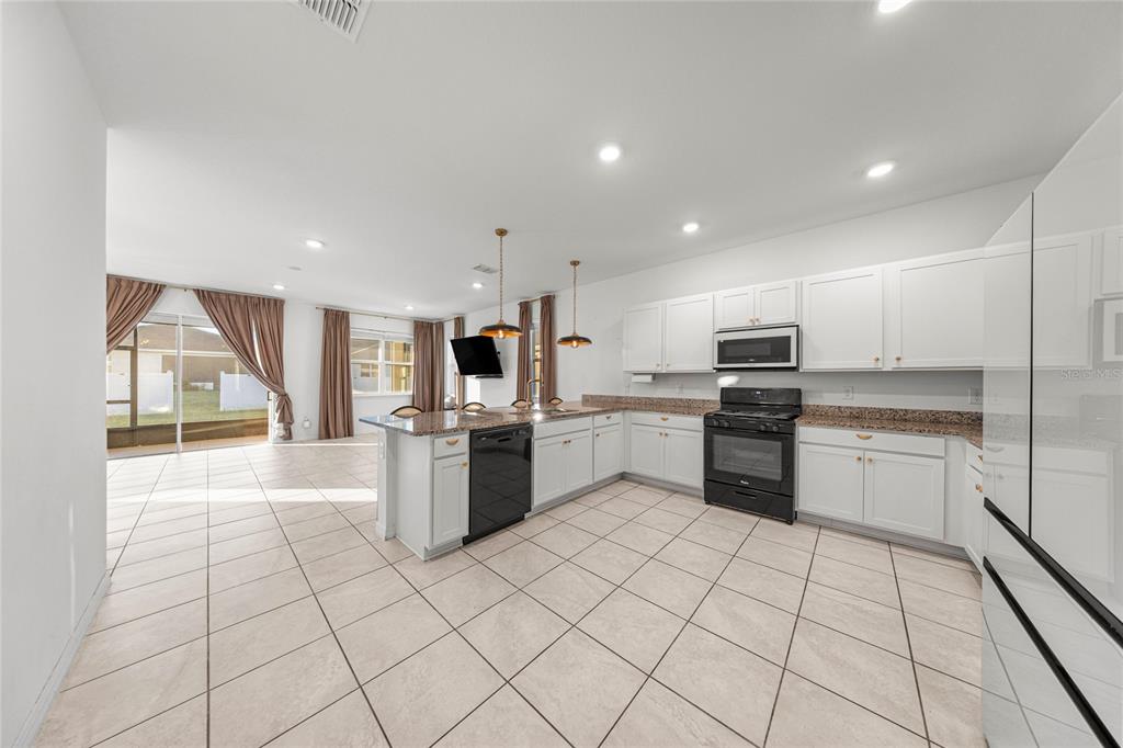 7664 Southwest 63rd Lane Road Ocala, FL 34474 - Photo 7 of 27 a kitchen with stainless steel appliances a refrigerator sink and microwave