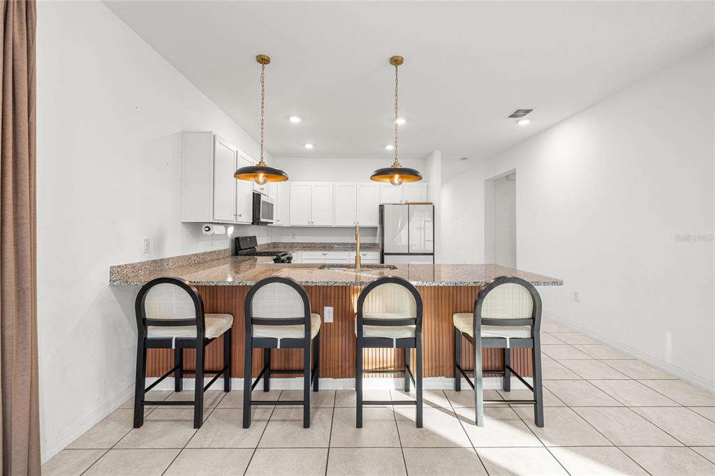 7664 Southwest 63rd Lane Road Ocala, FL 34474 - Photo 10 of 27 a hall with dining table and chairs