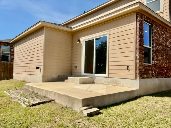 a view of house with backyard and windows