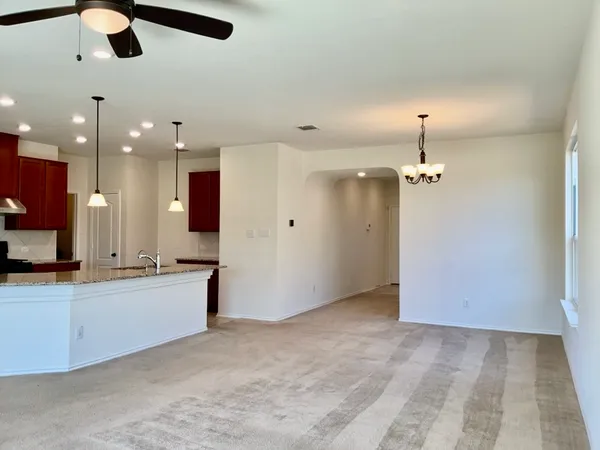 a view of a kitchen with a sink and chandelier