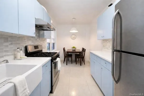 a kitchen with a sink a stove and chairs
