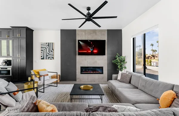 a living room with furniture fireplace and rug