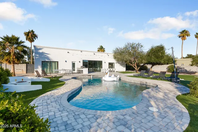 a view of a swimming pool with lounge chairs