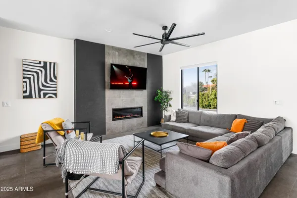 a room with furniture and a floor to ceiling window