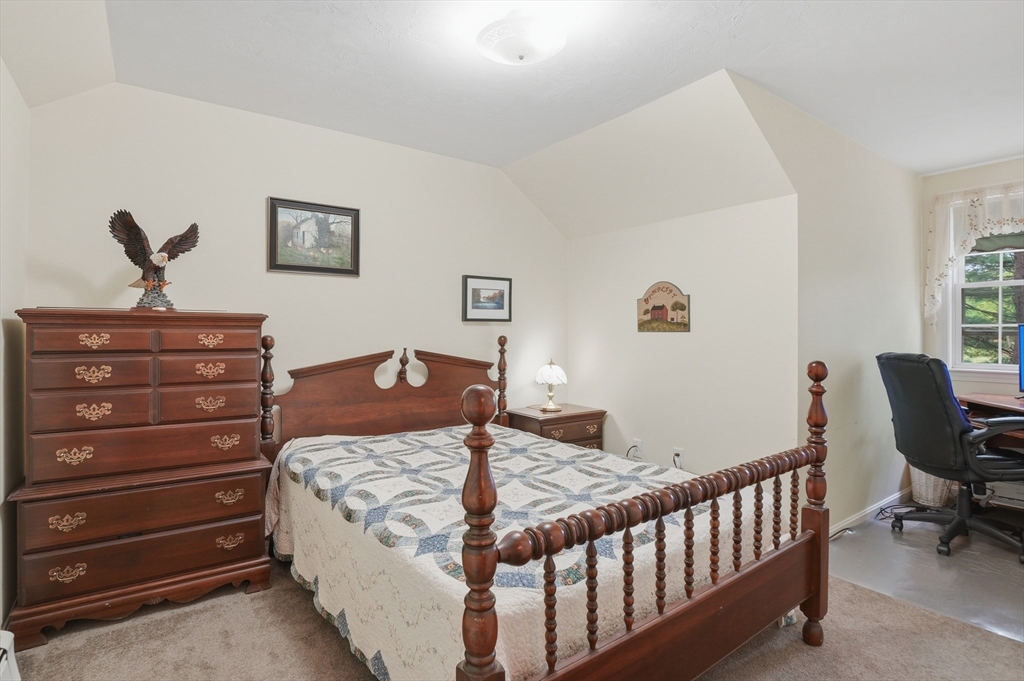 186 Common Street Groton, MA 01450 - Photo 23 of 28 a bed room with a bed and chair