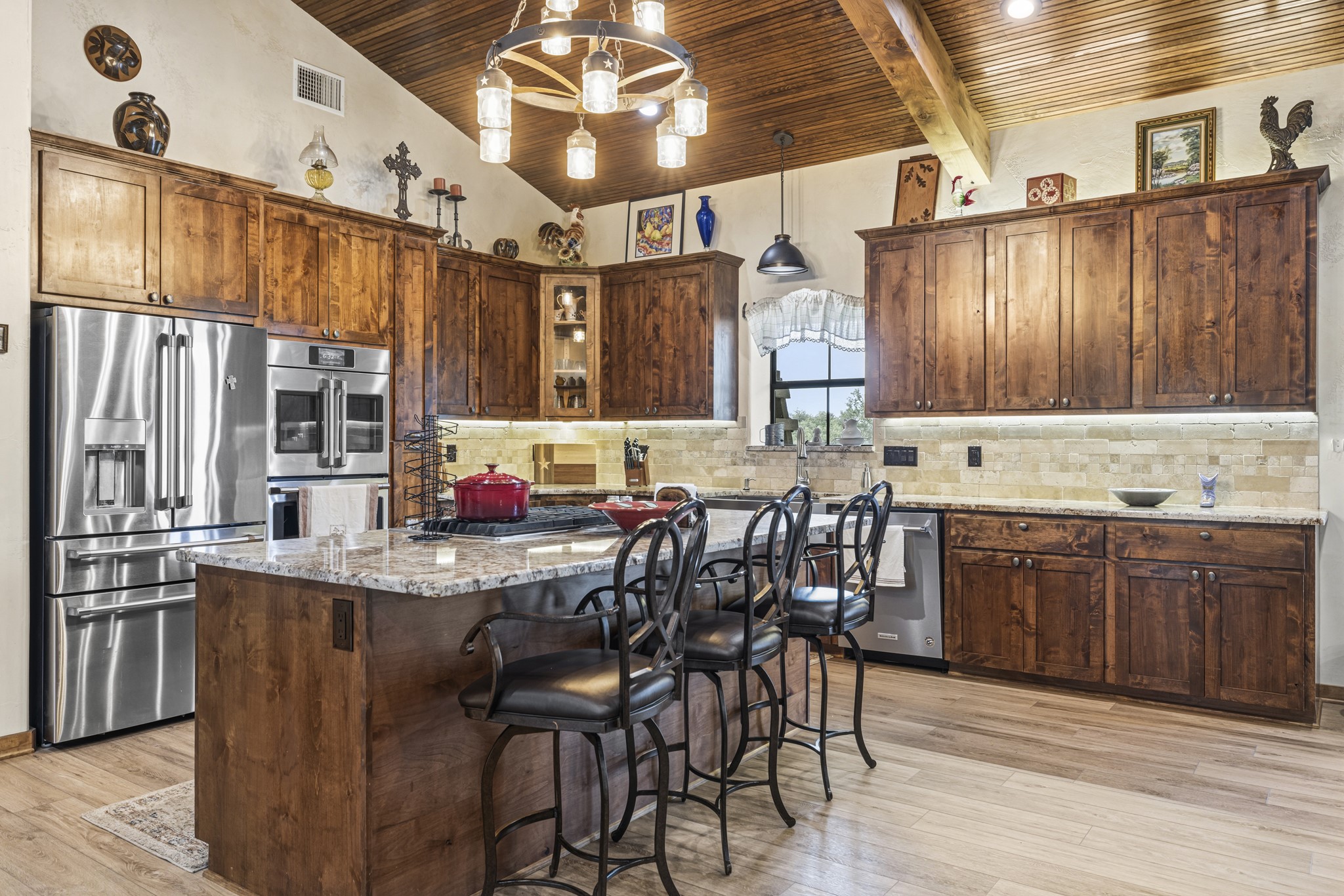 3724 Ranch Road 3347 Round Mountain, TX 78663 - Photo 8 of 40 a kitchen with stainless steel appliances kitchen island granite countertop a table chairs in it and wooden floors