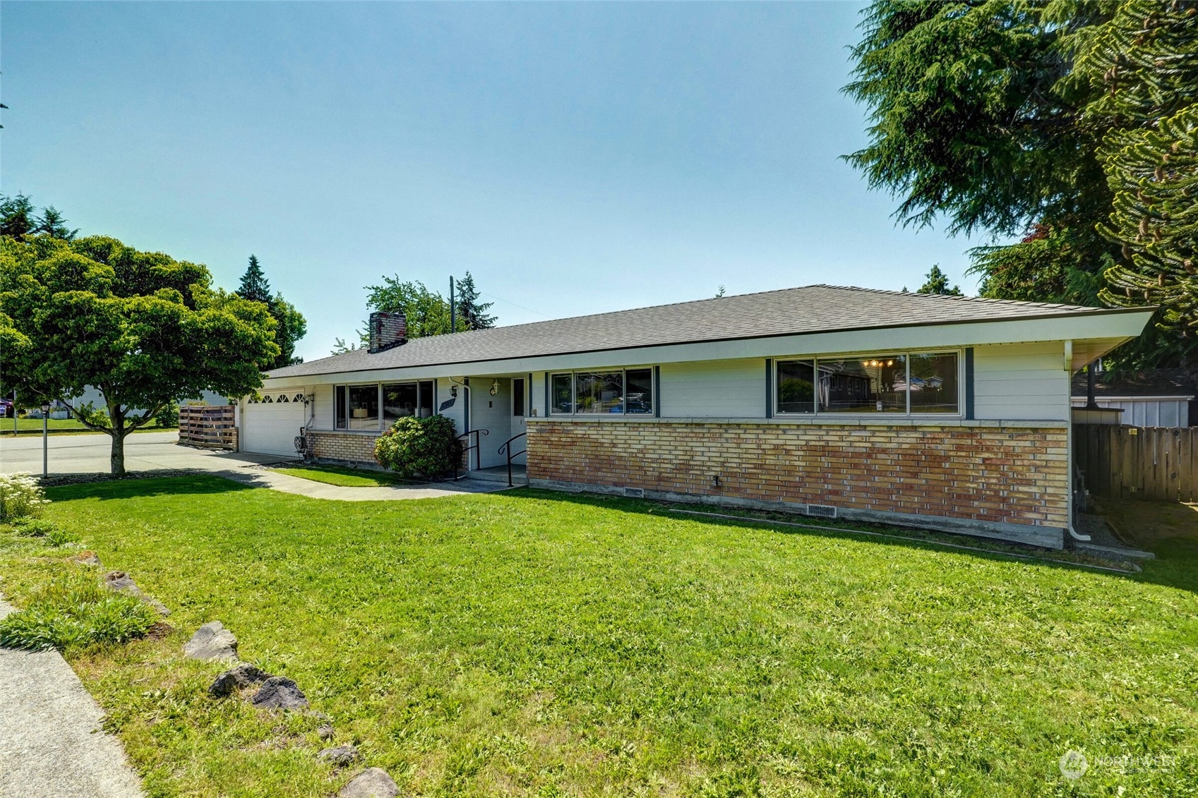 2309 Edmonds Avenue Northeast Renton, WA 98056 - Photo 35 of 35 a front view of a house with a garden