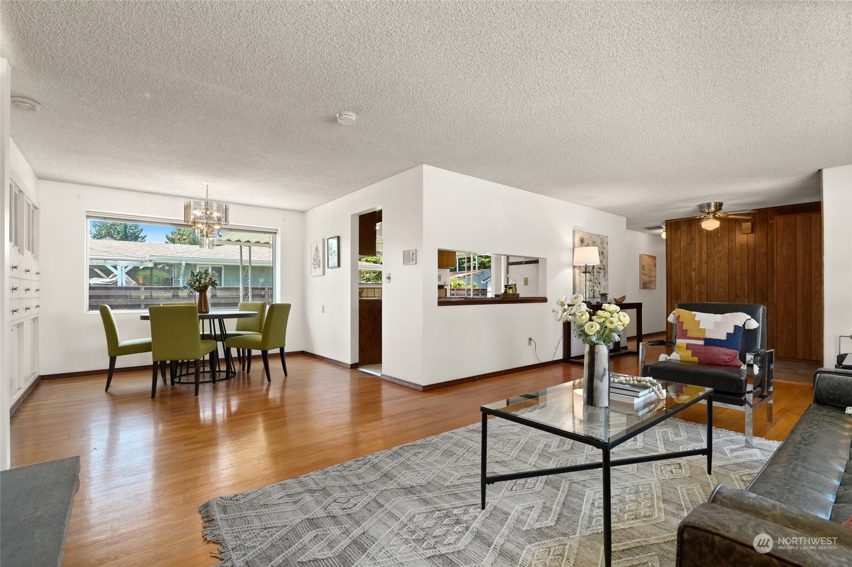 2309 Edmonds Avenue Northeast Renton, WA 98056 - Photo 7 of 35 a living room with furniture a table and kitchen view