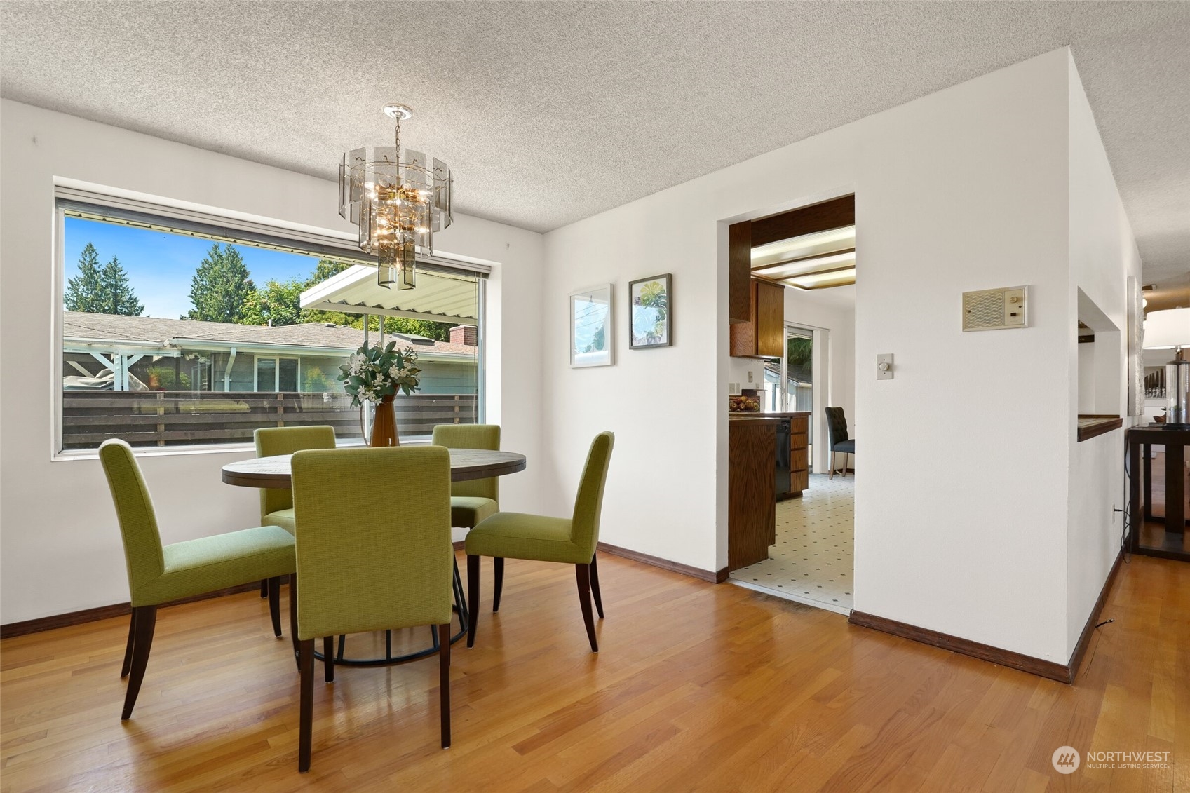 2309 Edmonds Avenue Northeast Renton, WA 98056 - Photo 8 of 35 a dining room with furniture a chandelier and wooden floor