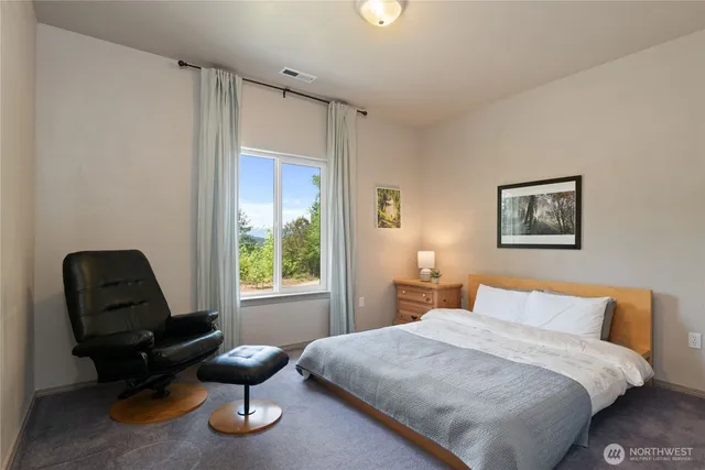 a bedroom with bed and flat screen tv