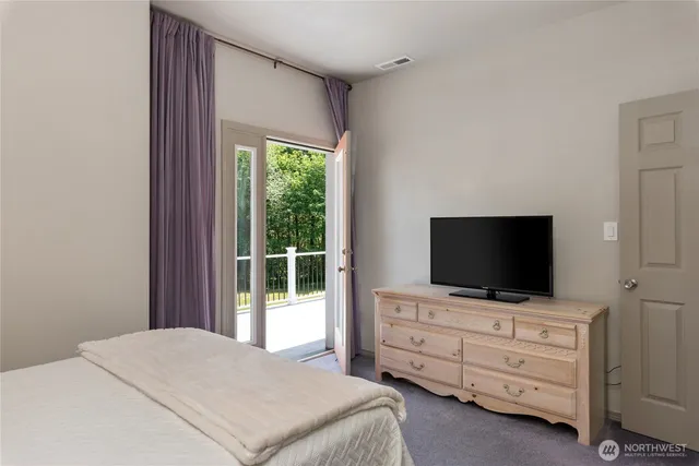 a bedroom with a bed and a view of bathroom