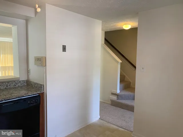 a view of a kitchen from the hallway