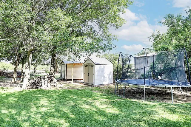 a backyard of a house with table and chairs