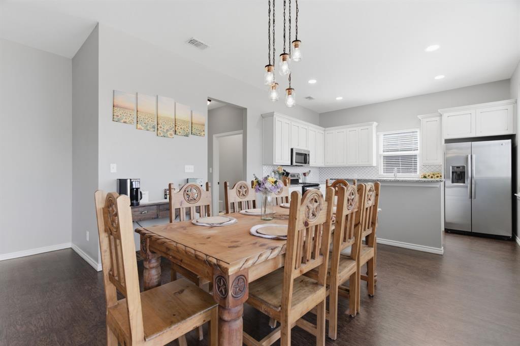 711 Hadley Lane Valley View, TX 76272 - Photo 6 of 40 Dining room featuring dark wood-type flooring and baseboards