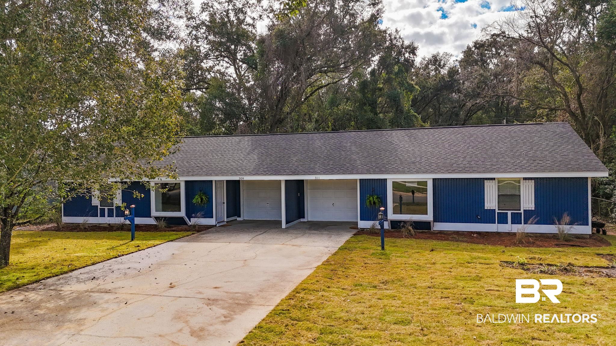309 West Roosevelt Avenue Foley, AL 36535 - Photo 2 of 60 Ranch-style home with a garage and a front lawn