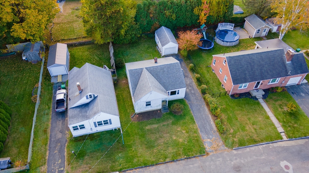 49 Bennett Street Chicopee, MA 01013 - Photo 37 of 42 an aerial view of a house with a swimming pool a yard and a garage