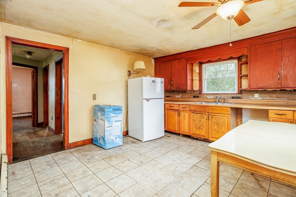 49 Bennett Street Chicopee, MA 01013 - Photo 4 of 42 a kitchen with a refrigerator a sink and dishwasher