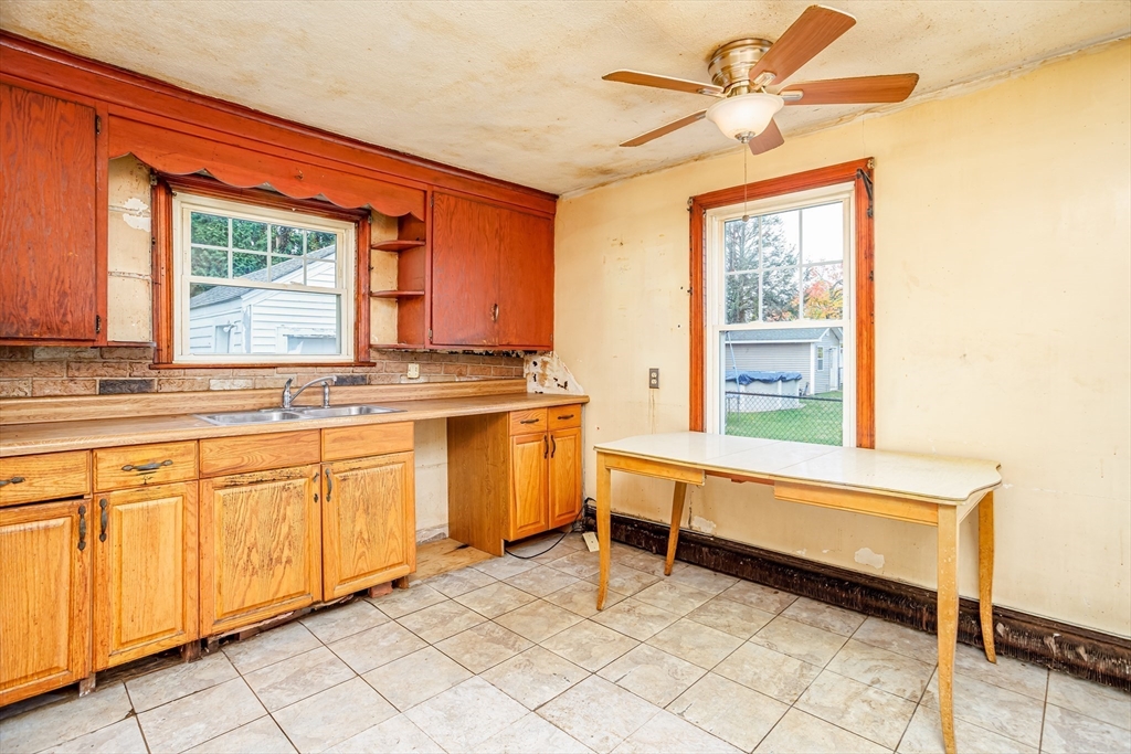 49 Bennett Street Chicopee, MA 01013 - Photo 5 of 42 a spacious bathroom with a granite countertop sink a mirror and a bathtub next to a window
