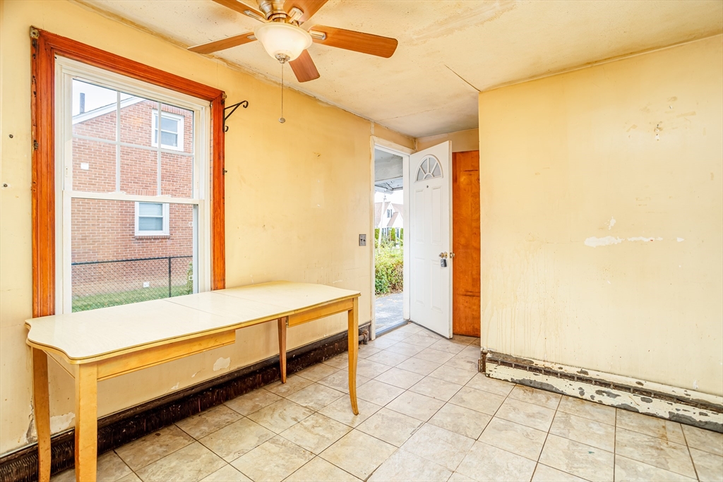 49 Bennett Street Chicopee, MA 01013 - Photo 6 of 42 a room with a table and a window