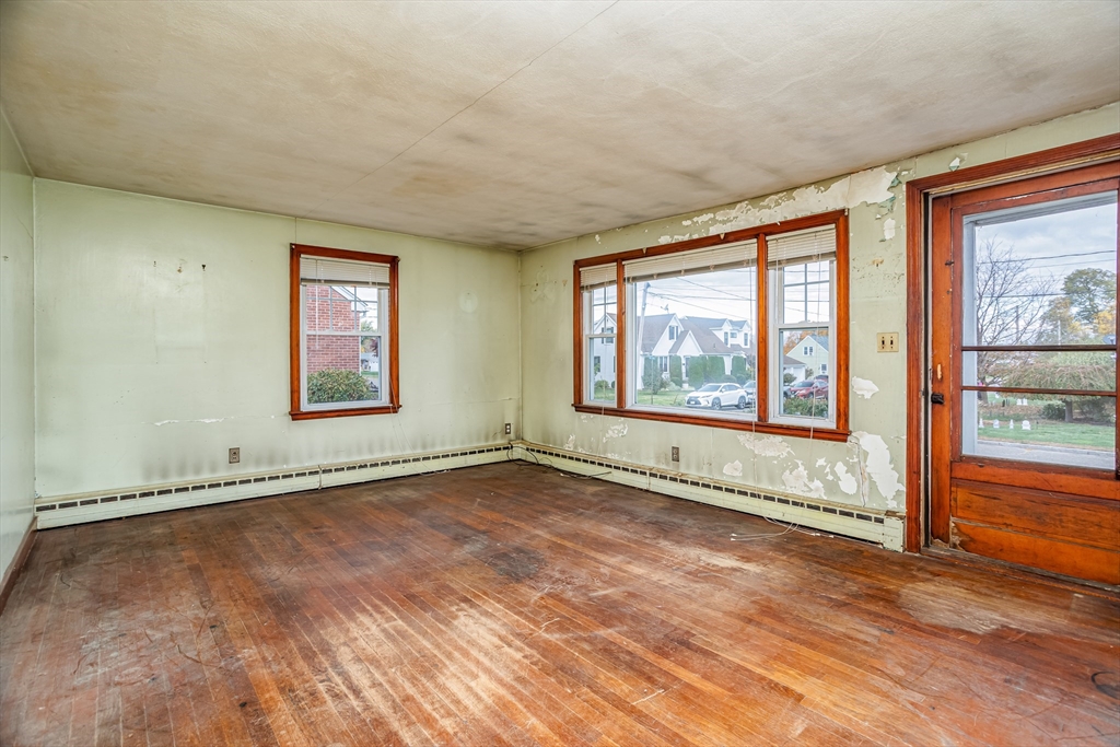 49 Bennett Street Chicopee, MA 01013 - Photo 8 of 42 an empty room with wooden floor and windows