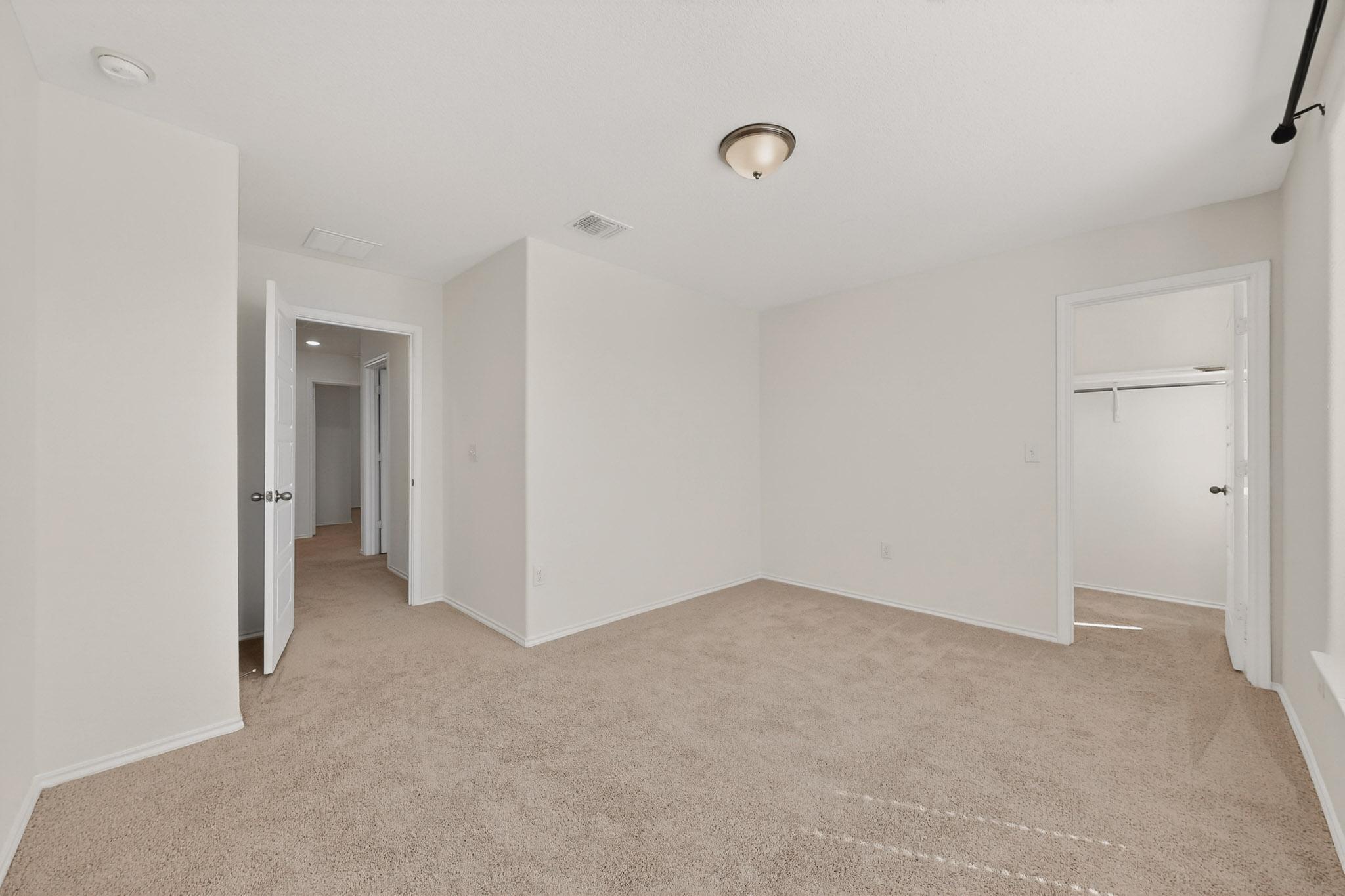 14513 Booted Eagle Pass Elgin, TX 78621 - Photo 28 of 33 Another view of the secondary bedroom showing its flexible layout and natural light. Walk-in closet even has a window.
