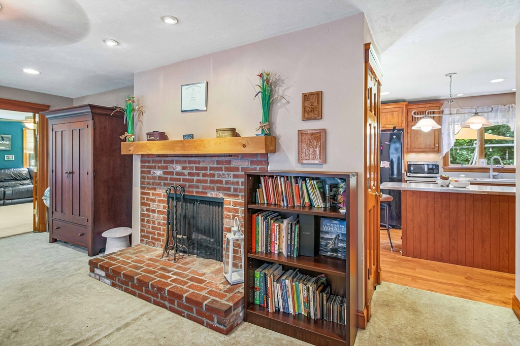 24 Manchaug Road Sutton, MA 01590 - Photo 12 of 40 a living room with furniture and a book shelf