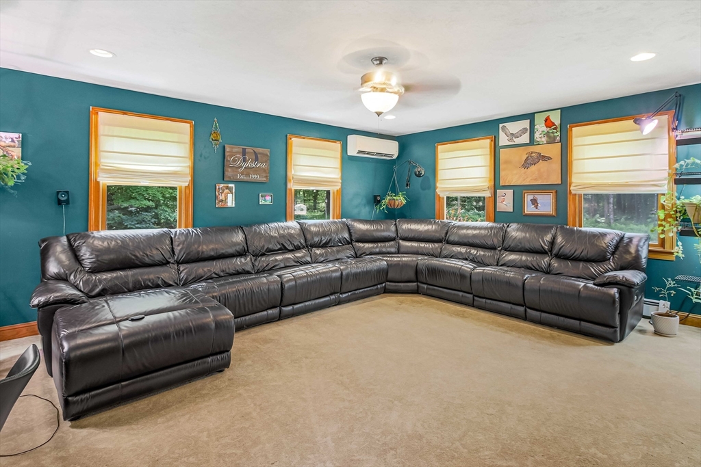 24 Manchaug Road Sutton, MA 01590 - Photo 15 of 40 a living room with furniture and a large window
