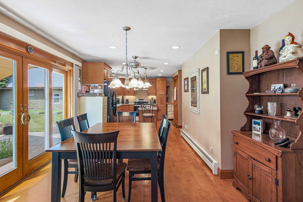 24 Manchaug Road Sutton, MA 01590 - Photo 18 of 40 a dining room with furniture a chandelier and wooden floor