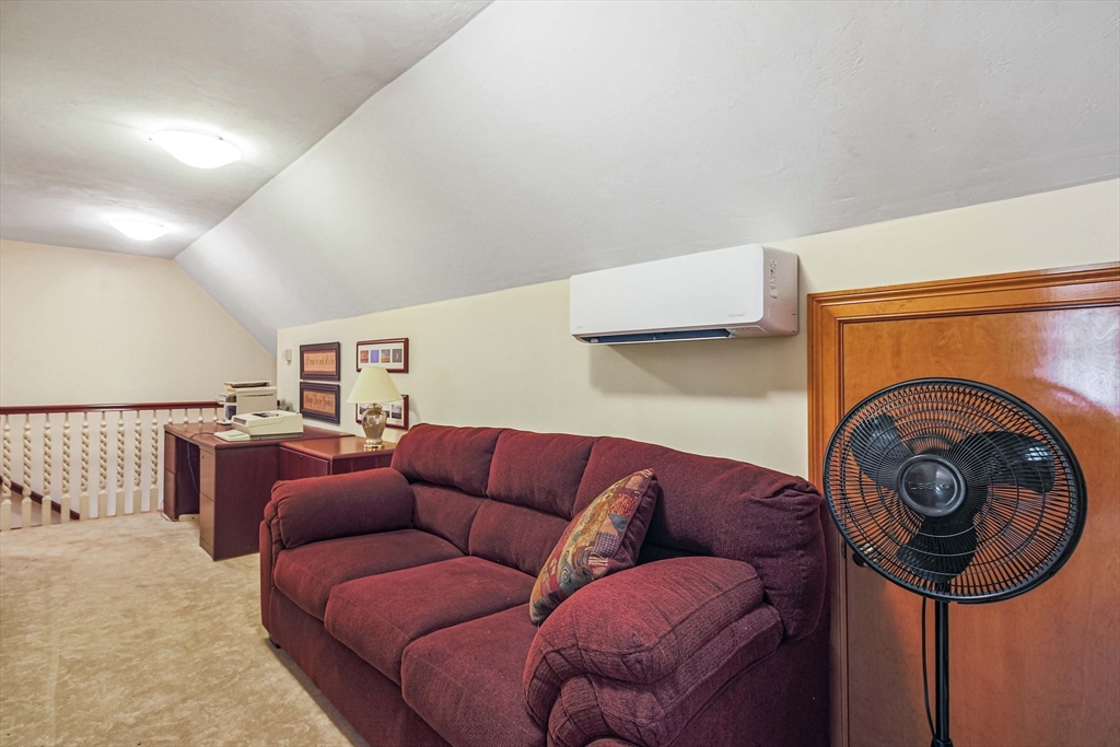 24 Manchaug Road Sutton, MA 01590 - Photo 25 of 40 a living room with furniture and a rug