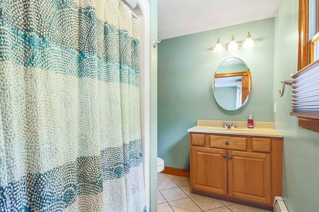 24 Manchaug Road Sutton, MA 01590 - Photo 34 of 40 a bathroom with a sink mirror and vanity
