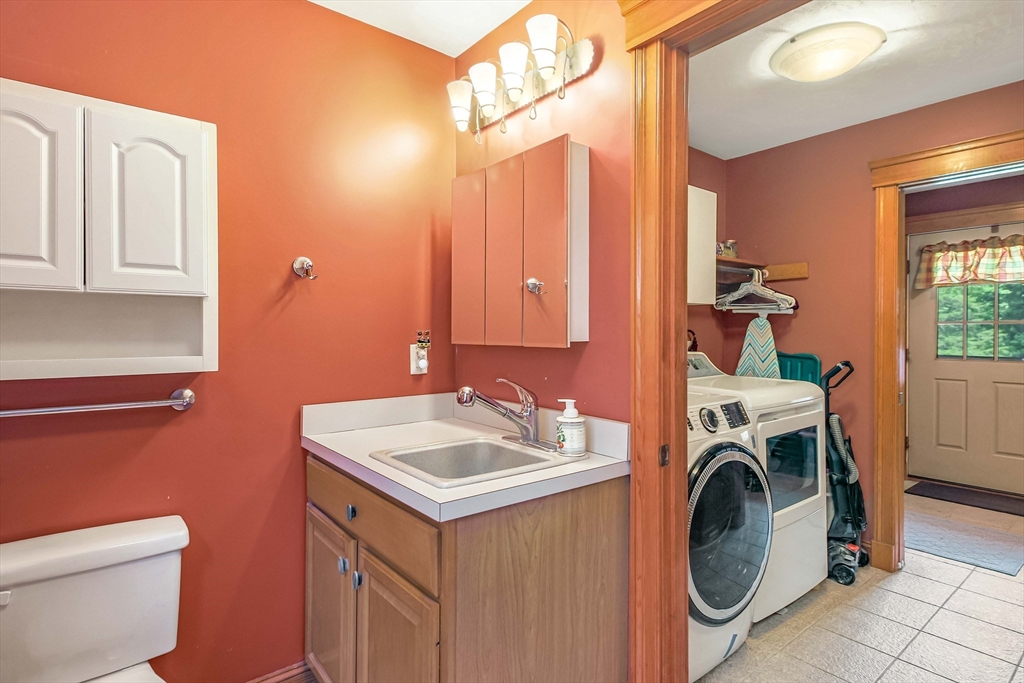 24 Manchaug Road Sutton, MA 01590 - Photo 8 of 40 a bathroom with a sink a washer and dryer
