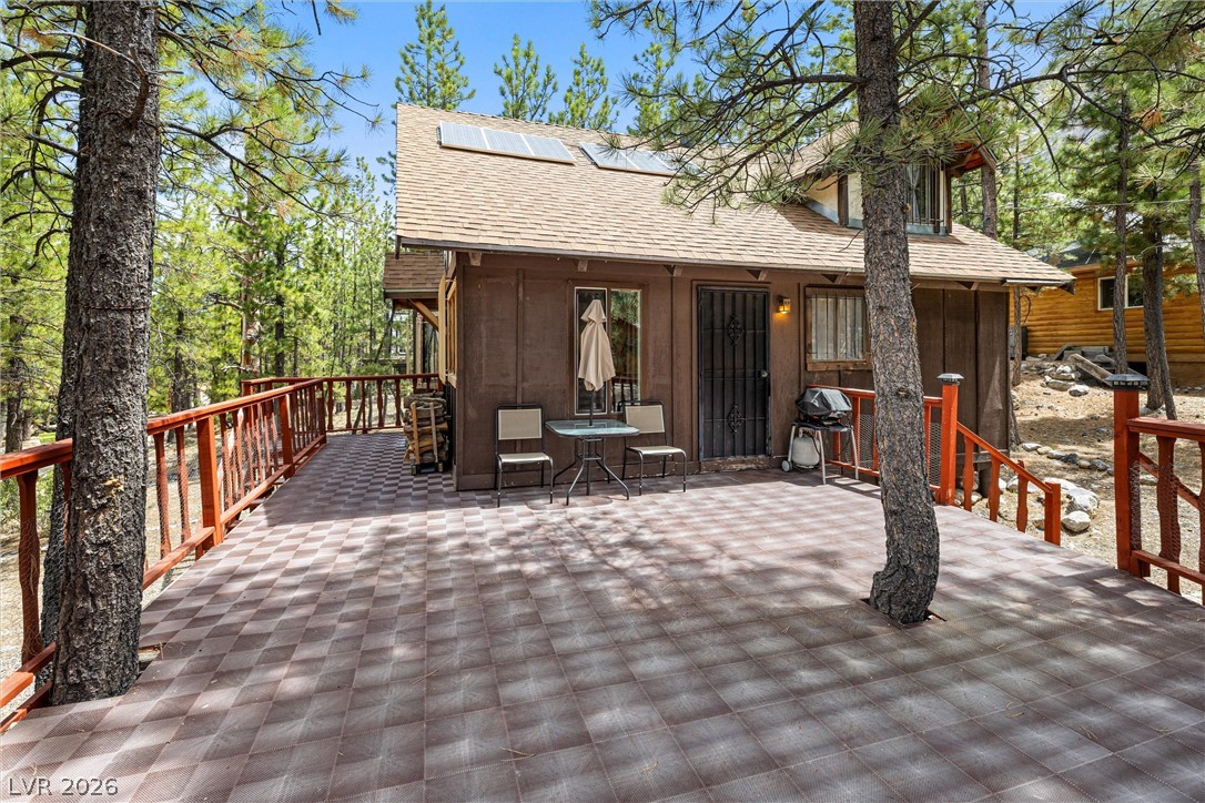 2146 Via Spes Nostra Street Mount Charleston, NV 89124 - Photo 7 of 33 An inviting outdoor deck, nestled among towering pines, offers space for relaxation and enjoyment.