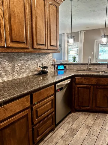 a kitchen with stainless steel appliances granite countertop a sink stove and cabinets