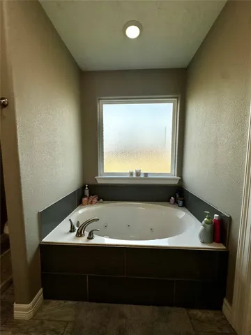 a bathroom with a bathtub and a sink