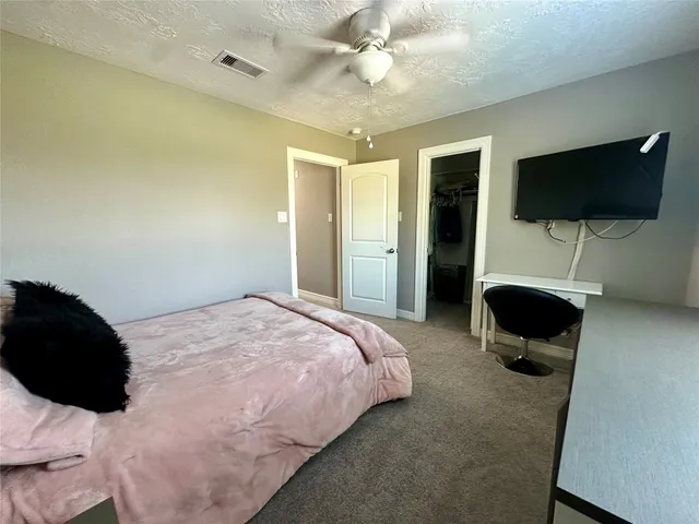 a bedroom with a bed and flat screen tv