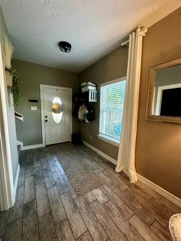 a view of a livingroom with wooden floor and window